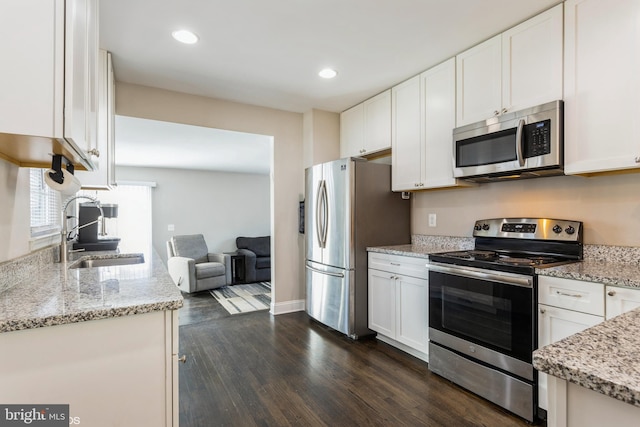 kitchen with white cabinets, stainless steel appliances, and a sink