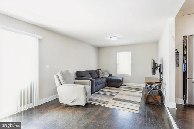 living area featuring baseboards and wood finished floors