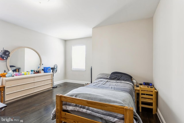 bedroom with baseboards and wood finished floors