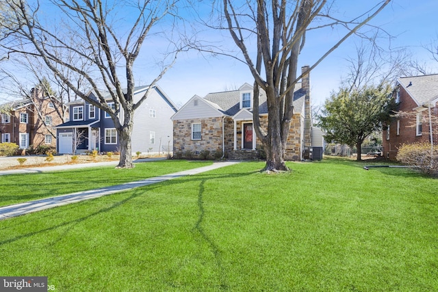 view of front of home with a chimney, cooling unit, stone siding, a residential view, and a front lawn