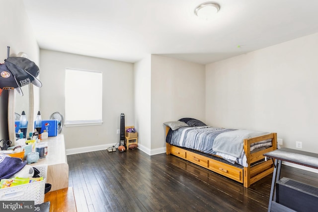 bedroom featuring hardwood / wood-style flooring and baseboards