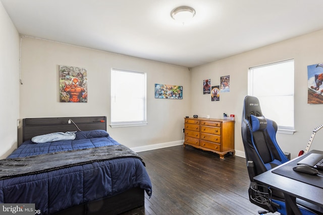 bedroom featuring baseboards and hardwood / wood-style flooring