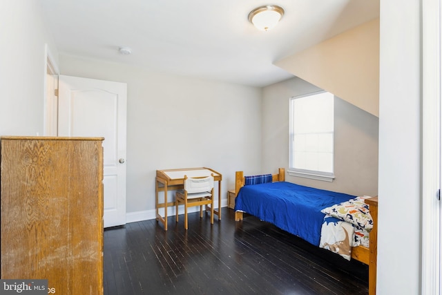 bedroom with baseboards and wood finished floors