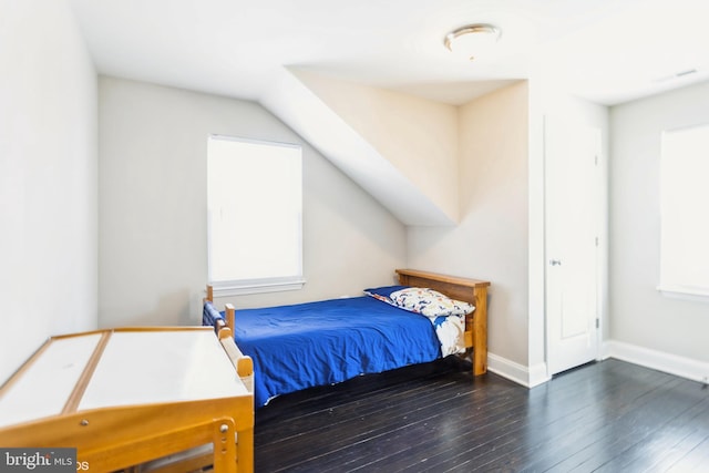 bedroom with baseboards and hardwood / wood-style floors