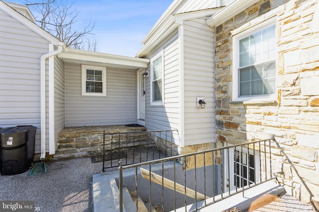 doorway to property with stone siding