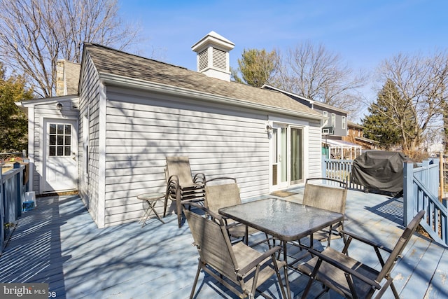 deck featuring outdoor dining area and grilling area