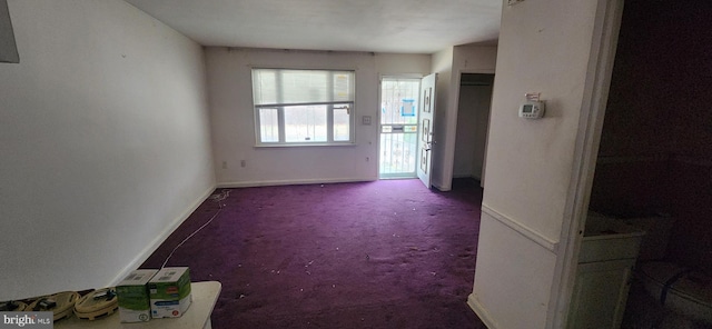 interior space with carpet floors and baseboards