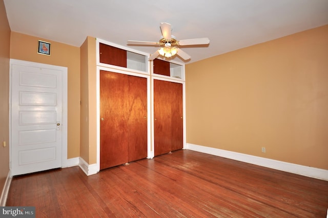 unfurnished bedroom featuring wood finished floors, a ceiling fan, and baseboards