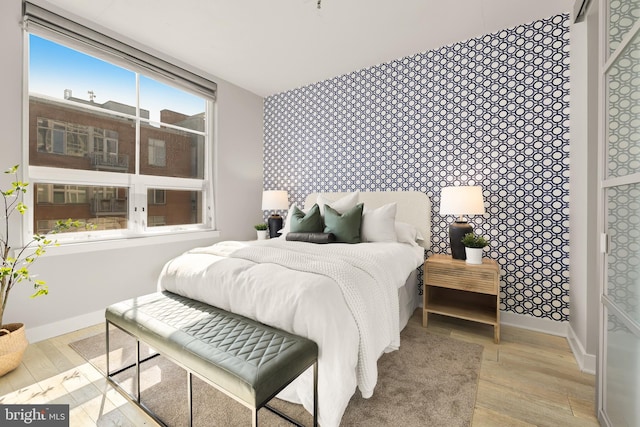 bedroom featuring wood finished floors and baseboards