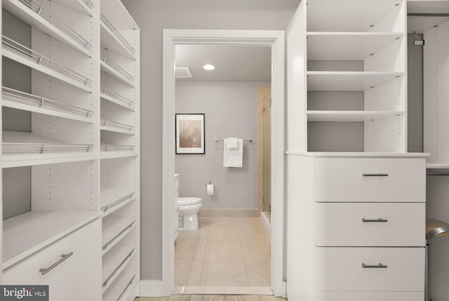 bathroom featuring visible vents, toilet, a stall shower, tile patterned flooring, and baseboards