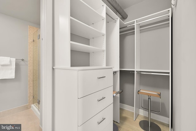 walk in closet featuring light wood-style flooring