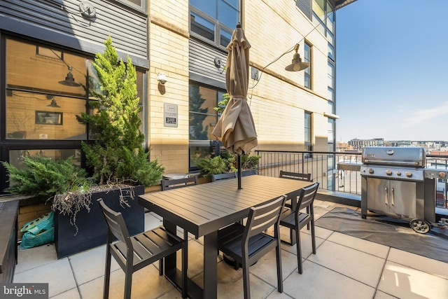 view of patio featuring a city view, outdoor dining area, and area for grilling