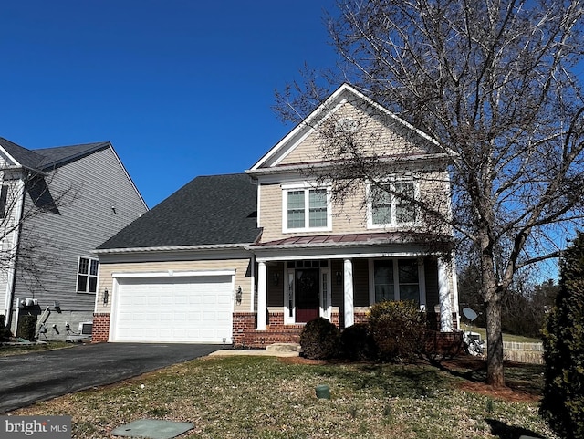 traditional-style house featuring aphalt driveway, a garage, covered porch, brick siding, and a front lawn