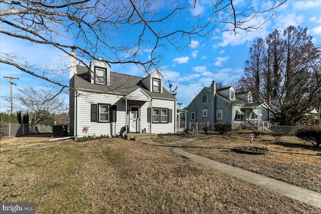 cape cod house featuring a chimney, a front lawn, and fence