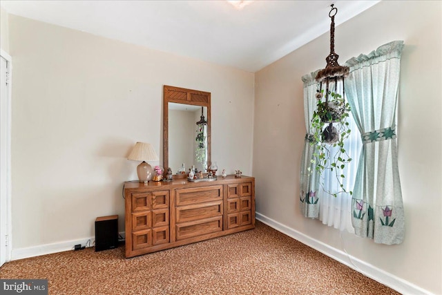 bedroom featuring baseboards and light carpet