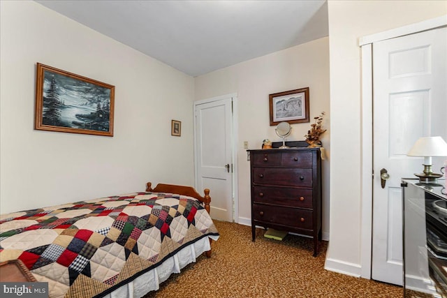 bedroom with baseboards and carpet