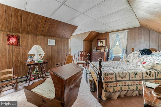 carpeted bedroom featuring vaulted ceiling and wooden walls