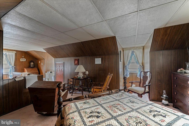 bedroom with wooden walls and carpet floors