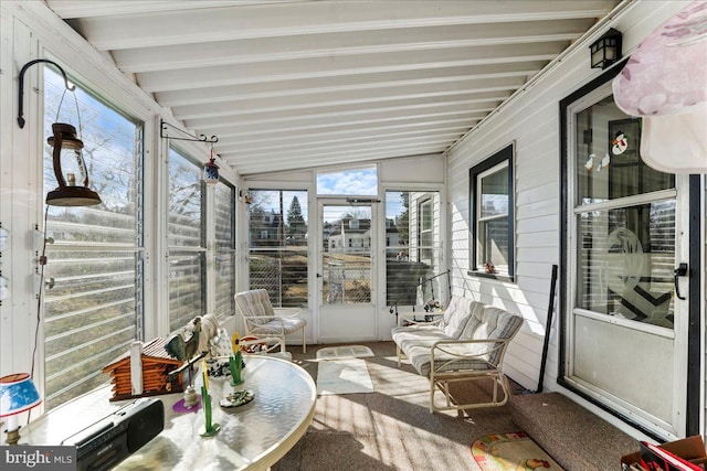 sunroom / solarium with lofted ceiling with beams