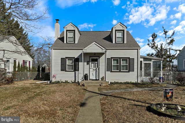 new england style home featuring roof with shingles, fence, central AC, and a chimney