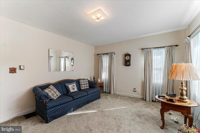 carpeted living room with baseboards