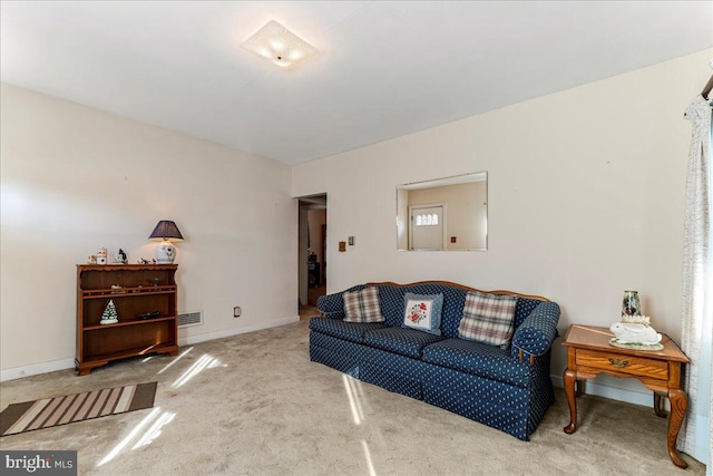 living area featuring visible vents, carpet flooring, and baseboards