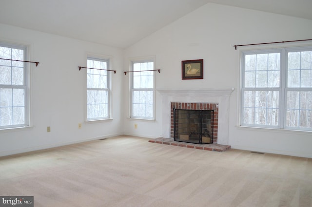 unfurnished living room featuring vaulted ceiling, carpet flooring, a fireplace, and baseboards