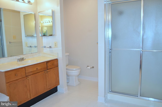 bathroom featuring vanity, toilet, baseboards, and a shower with door