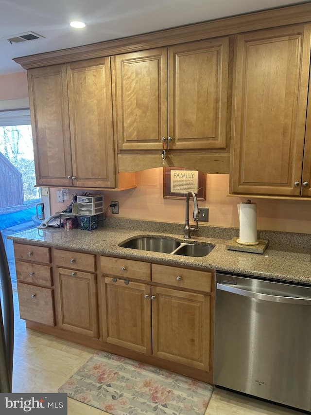 kitchen with light stone countertops, a sink, visible vents, stainless steel dishwasher, and brown cabinets