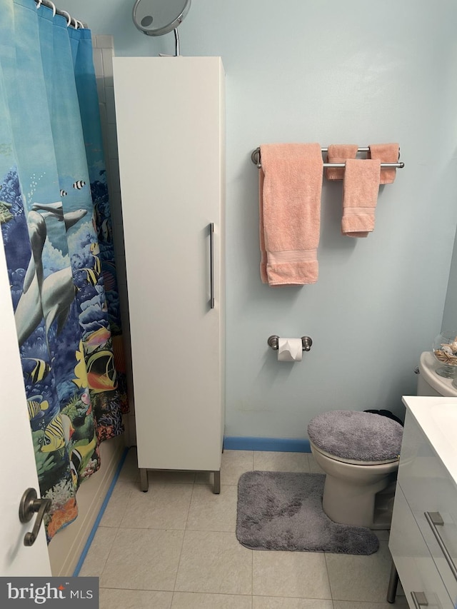 bathroom featuring toilet, tile patterned flooring, a shower with shower curtain, and vanity