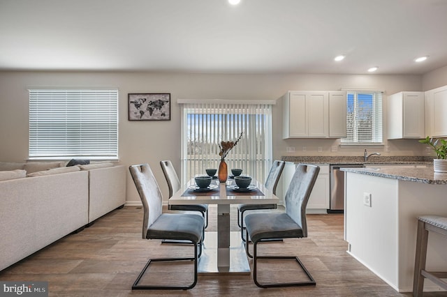 dining room with light wood finished floors and recessed lighting