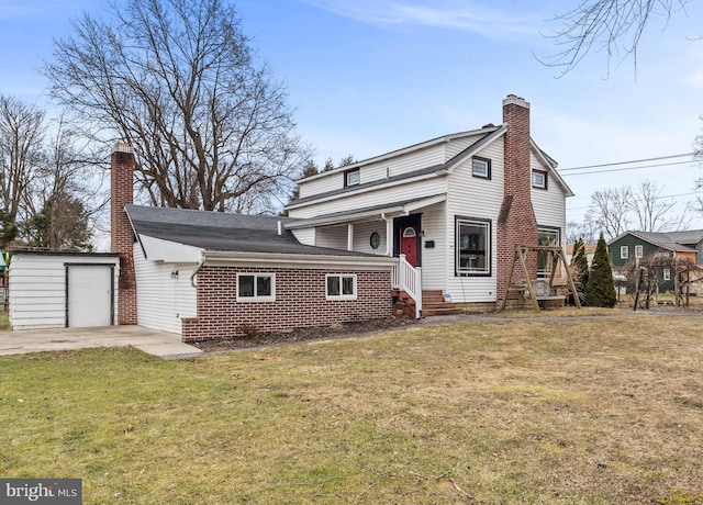 view of front of property featuring an outbuilding, a chimney, a front yard, and a garage