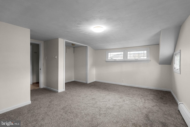 unfurnished bedroom featuring carpet floors, baseboard heating, and baseboards