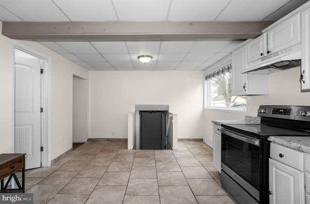 kitchen featuring a paneled ceiling, under cabinet range hood, white cabinetry, and stainless steel range with electric cooktop