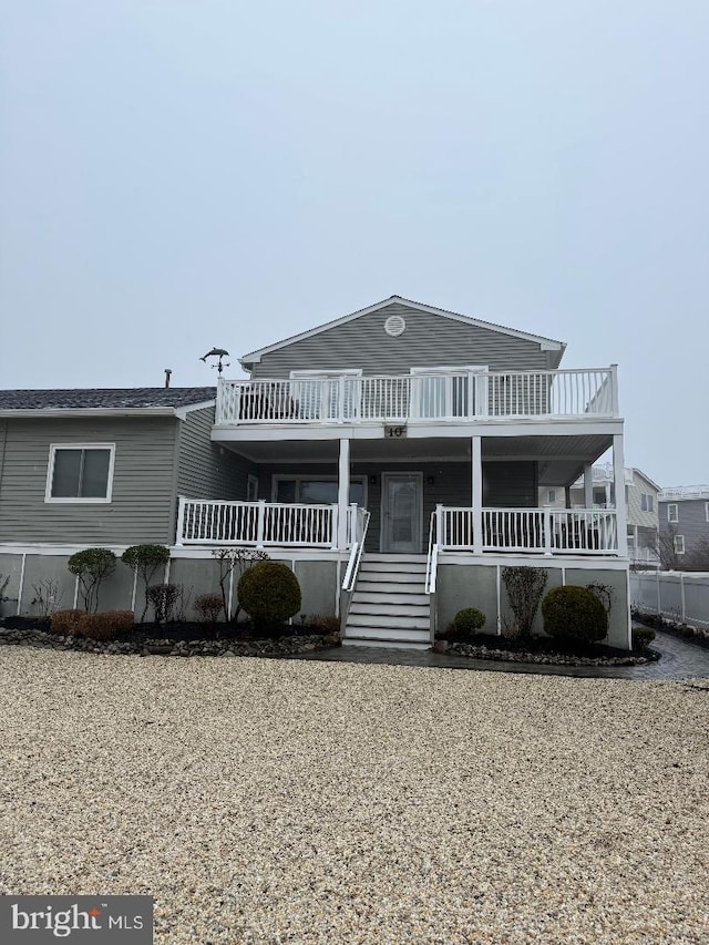 view of front of house with stairway and covered porch