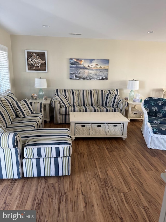 living area with wood finished floors and visible vents