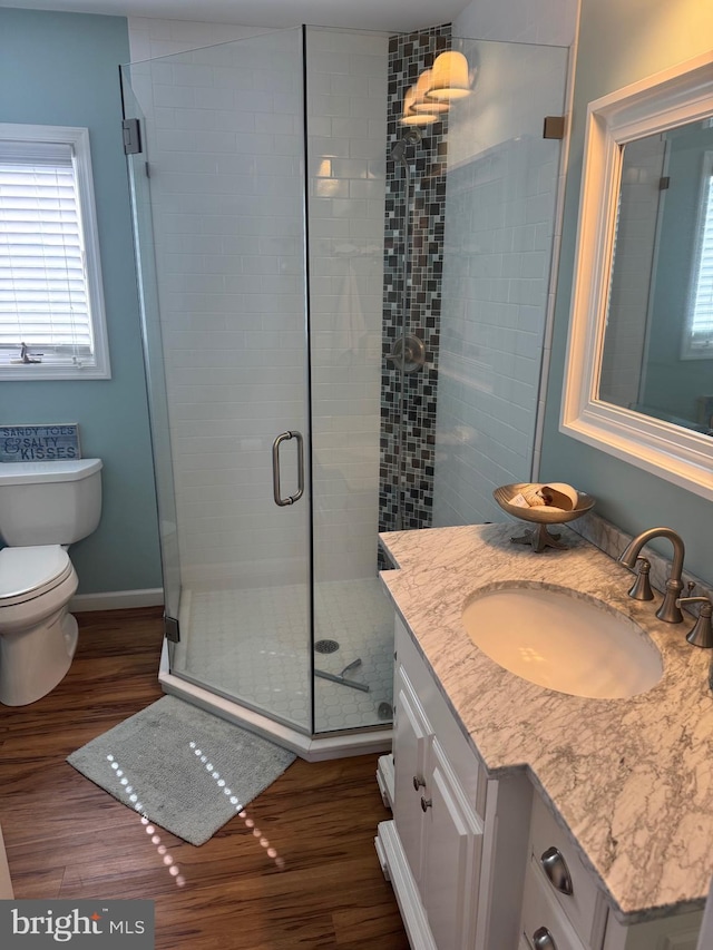 10 W Essex Ave, Harvey Cedars, NJ 08008 - full bath featuring vanity, toilet, wood finished floors, a shower stall, and plenty of natural light
