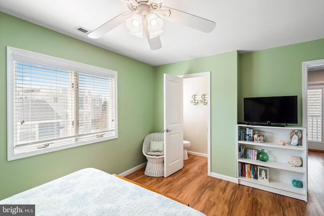 10 W Essex Ave, Harvey Cedars, NJ 08008 - bedroom featuring baseboards, wood finished floors, and a ceiling fan