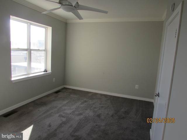 unfurnished room featuring ornamental molding, visible vents, dark carpet, and baseboards