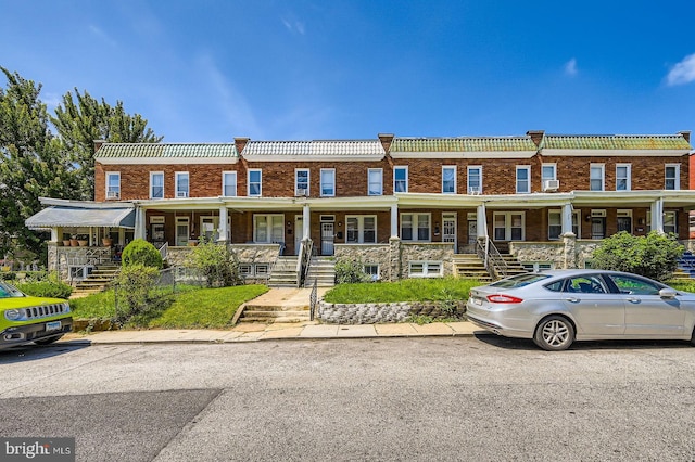 5312 Cordelia Ave, Baltimore, MD 21215 - townhome / multi-family property featuring covered porch, stairs, and brick siding