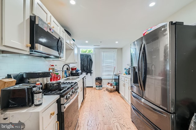 5312 Cordelia Ave, Baltimore, MD 21215 - kitchen with appliances with stainless steel finishes, white cabinetry, light countertops, light wood finished floors, and recessed lighting