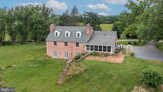 exterior space featuring a lawn and a chimney