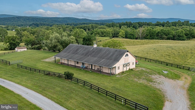 birds eye view of property with a rural view, a wooded view, and a mountain view