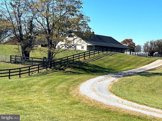view of yard with driveway and fence