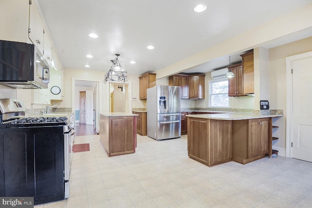 kitchen featuring a wall unit AC, recessed lighting, hanging light fixtures, appliances with stainless steel finishes, and a peninsula