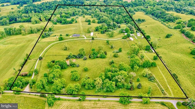birds eye view of property with a rural view