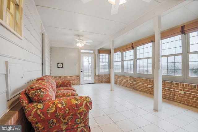 sunroom / solarium featuring a ceiling fan
