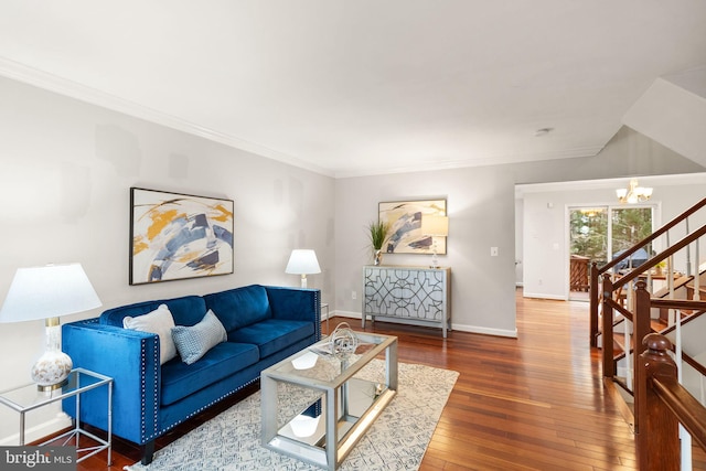 living room with crown molding, wood-type flooring, stairway, an inviting chandelier, and baseboards