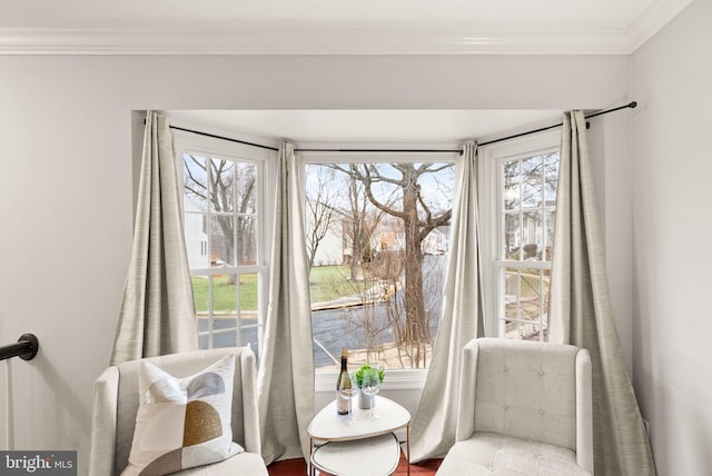 living area with plenty of natural light and crown molding