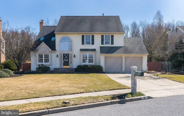 traditional-style house with driveway, a chimney, an attached garage, fence, and a front lawn